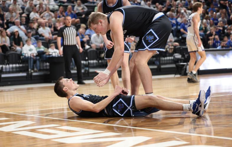 West Central teammates helping one another from the floor